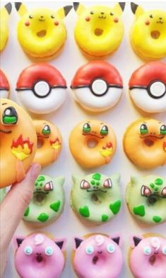 a person holding a doughnut in front of pokemon donuts