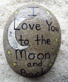 a rock with the words i love you to the moon and back written on it