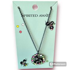 the necklace is decorated with black beads and small animals on it's chain,