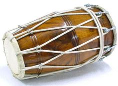 a close up of a small wooden drum on a white surface with rope around it