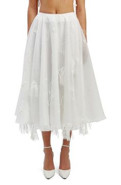 Here's an organza midi skirt that proves that everything is more fun when you add fringe. 30 1/2" length Hidden side-zip closure Lined 100% polyester Hand wash, line dry Imported Chic Spring Skirt With Tassels, Chic Skirt With Tassels For Spring, White Midi Length Party Bottoms, White Midi-length Bottoms For Evening, White Midi Party Bottoms, White Midi Length Bottoms For Evening, Spring Party Organza Skirt, Spring Long Skirt With Tassels, Spring White Skirt With Tassels