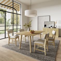 a dining room table and chairs in front of a large window