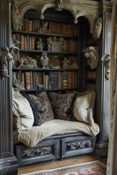 an old bookcase with many books and pillows on it in front of a window