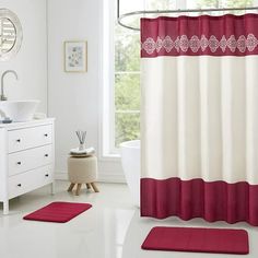 a red and white shower curtain in a bathroom