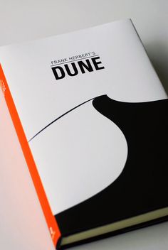 an orange and white book sitting on top of a table