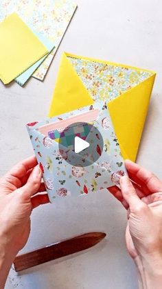 someone is making an origami box out of paper