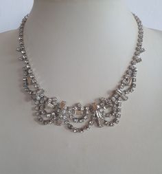 superb ART DECO rhodium plate hand prong set crystal paste rhinestone choker bib adjustable necklace with elaborate design - vintage. A beautiful ''something old'' for a bride or for any other special occasion! Good vintage condition will all stones in place.  inches end to end when closed. IMPORTANT TO READ: To make this a smooth and pleasant transaction experience for everyone, all buyers need to read and understand the description, the terms of sale , the payment and the shipping indicated in this listing. TERMS OF SALE A. SHIPPING WORLDWIDE This listing includes payable tracked services with the fees indicated below.  B. CARRIERS We don't ship with FedEx, DHL or UPS or any other carrier except for Canada Post unless a specific agreement with the buyer is accepted by us at our sole disc Metal Rhinestone Necklace For Weddings, Costume Jewelry Style, Metal Rhinestone Necklace For Wedding Costume Jewelry, Costume Jewelry Metal Rhinestone Necklace For Wedding, Costume Jewelry Rhinestone Necklace For Wedding, Metal Rhinestone Costume Necklace For Weddings, Round Metal Rhinestone Necklace For Wedding, Round Rhinestone Metal Necklace For Wedding, Metal Bridal Necklace With Rhinestones For Wedding, Round Rhinestone Necklace For Wedding