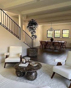 a living room filled with furniture and a staircase