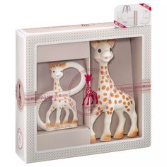 two toy giraffes in a box on a white background with pink trim