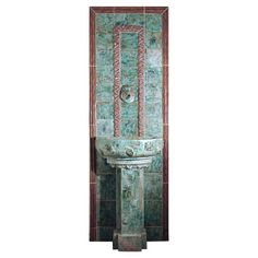 a green and red wall mounted fountain