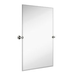 a mirror that is on top of a white wall mounted cabinet with two knobs