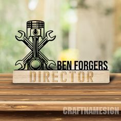 a wooden sign that says ben forgers direetor on top of a table