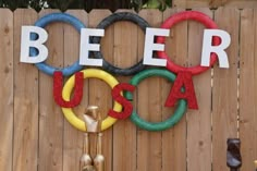 a sign that says beer usa next to a fence with rings and letters on it