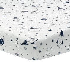 an image of a baby crib sheet with rockets and stars on it in white