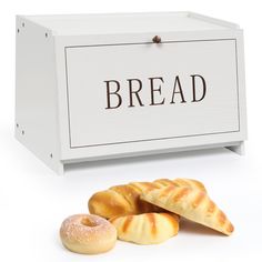 bread and bagels sitting next to a white box with the word bread on it