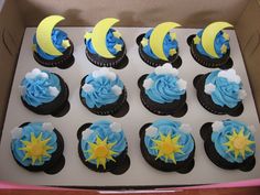 twelve cupcakes in a box with moon and stars on them