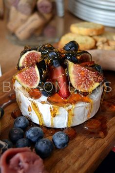 a cheese dish with figs and blueberries on it