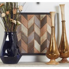 three vases with flowers in them sitting on a shelf