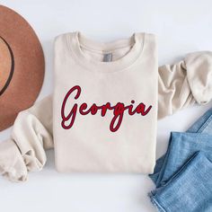 Atlanta Shirt, Georgia Shirt, GA Shirt, College Shirt, Game Day Shirt, Cute Georgia Shirt, Women's Georgia Shirt, Georgia Gifts, Tee SHIPS IN 1-2 BUSINESS DAYS.. PLEASE IGNORE ETSY'S SHIPPING TIMES, IT IS NOT ACCURATE    .: Made with a medium-heavy fabric blend of 50% cotton and 50% polyester (8.0 oz/yd² (271.25 g/m this sweatshirt feels cozy and is the perfect choice for those colder months. .: The classic fit along with the crew neckline deliver a comfy wearing experience with a clean-cut styl Georgia Sweatshirt, Georgia Shirt, College Crewneck, College Shirt, Bless Your Heart, College Shirts, Game Day Shirts