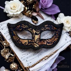 Venetian style masquerade mask covered black lace on metallic gold surface. Framed with black braided trim, small black rhinestones on the corners of the eyes. Your order will be delivered with online tracking by UPS or FedEx.  Back surface is also covered with fabric for comfortable use. Ribbons are added both sides to tie. Base mask is made of paper mache.  Standard size fits most (for women). This classical Venetian mask is perfect for any costume or Halloween party, masquerade, carnival, wedding, prom. I recreate this design after each sale. Since it's totally handmade, the mask you will receive may vary slightly from the one seen in the photo. Also please note that color tones may look slightly different depending on your monitor settings.  For all items on Soffitta: www.etsy.com/shop Lace Masquerade Mask, Mask Ball, Lace Masquerade Masks, Masquerade Carnival, Masquerade Ball Mask, Venetian Masquerade Masks, Ball Mask, Venetian Masquerade, Masquerade Masks