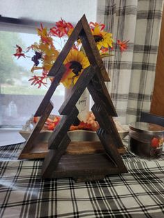 a small wooden triangle sitting on top of a table