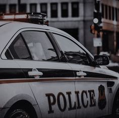 the police car is parked on the side of the street