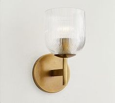 a light that is on the side of a wall with a glass shade over it