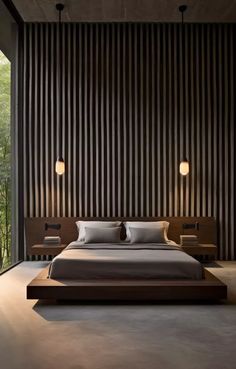 a large bed sitting in the middle of a bedroom next to a tall wooden wall