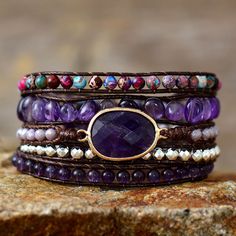 Elevate Your Spiritual Journey with Our Handmade Amethyst Beaded Wrap Bracelet Discover the perfect blend of earthy charm and spiritual energy with our unique, handmade Spiritual Amethyst Beaded Wrap Bracelet. Crafted from strands of brown leather, this exquisite piece features amethyst and jasper stone beads, mixed crystal beads, and an oval-shaped amethyst centerpiece. Designed for a 5-wrap fit, it's the ideal accessory to showcase your individuality and enhance your spiritual connection. Hand Amethyst Protection, Yoga Bracelet Beads, Amethyst Crystal Bracelet, Purple Jasper, Wrap Armband, Beaded Leather Wraps, Tiger Eye Jewelry, Rose Quartz Jewelry, Cord Wrap