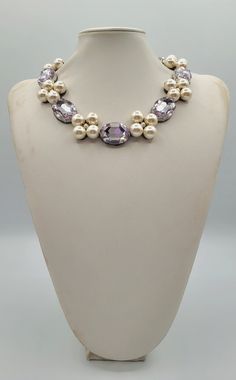 Each piece of our statement necklaces is handmade and one of a kind made in Italy. Our creations is made of high quality materials such as crystals and rhinestones. Each embroidered material is carefully hand sewn. Very glamorous and stylish. Perfect gift to someone you like. Materials Strass stones in  Violet color and White pearls.  Black eco leather backing. Aluminium color hook closure. Measurements Weight approximate 150 grams. Circumference approximate 59 cm - 23,22 in Feel free to contact us if you have any question. Thank you so much for looking at our shop and our articles each of them, single piece. Elegant Handmade Crystal Rhinestone Necklace, Elegant Crystal Beaded Necklaces With Stones, Unique Pearl Necklaces For Party, Handmade Elegant Crystal Rhinestone Necklace, Elegant Party Beaded Necklaces With Stones, Elegant Beaded Necklaces With Stones For Party, Pearl Jeweled Necklaces For Gifts, Elegant Jeweled Beaded Necklaces For Party, Pearl Jeweled Necklaces As Gift