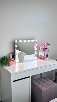 a white desk with a mirror and lights on it