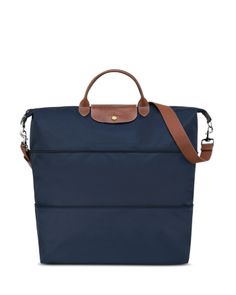 a large blue bag with brown straps