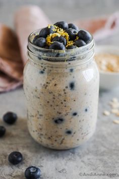 a jar filled with blueberries and oatmeal on top of a table