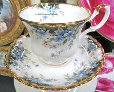 an antique tea cup and saucer with blue flowers