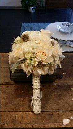 a bridal bouquet sitting on top of a wooden table