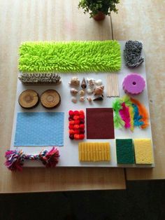 a table topped with lots of different types of crafting supplies on top of a wooden table