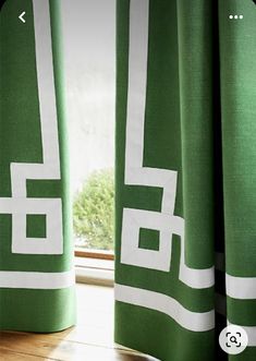 green and white curtains in front of a window with the word'e'on it