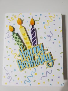 a birthday card with candles and confetti