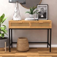 a wooden table with two plants on top and a mirror above it next to a potted plant