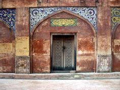 an old building with a wooden door and ornate designs