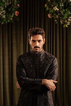 A black cotton silk kurta and pajama set with floral patterns merged with an inner border details, further accentuated with all over sequin details. 

Color: Black
Fabric: Cotton Silk