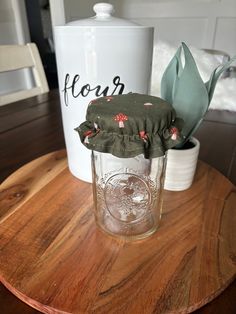 a glass jar sitting on top of a wooden table