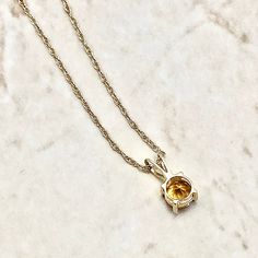 Beautiful pendant necklace crafted in 14 karat yellow gold. It features a natural 5 mm round citrine, the birthstone for November! The gemstone weighs approximately 0.45 carat. It comes with an 18-inch 14 karat yellow gold chain. Birthstone: November. Condition: Brand New. - 14 day return policy, no questions asked. - Free insured shipping in the US. - International shipping available. Note: All items have been appraised and inspected by a jewelry specialist and certified gemologist (GIA GG). All diamond and gemstone gradings are done under GIA standards as the mounting and setting permit. All gemstone weights and item measurements are approximate. All diamond colors and clarities are based on the opinion of our experienced gemologist. Feel free to call or message us if you have any questi Edwardian Style Engagement Ring, Smoky Quartz Jewelry, Gemstone Rings Vintage, December Birthstone Jewelry, Gold Chain Earrings, Beautiful Pendant Necklace, Citrine Jewelry, Peridot Jewelry, Citrine Pendant