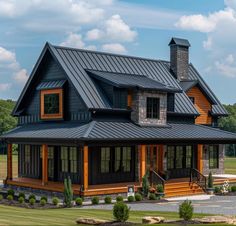 a large house with a metal roof in the middle of a field