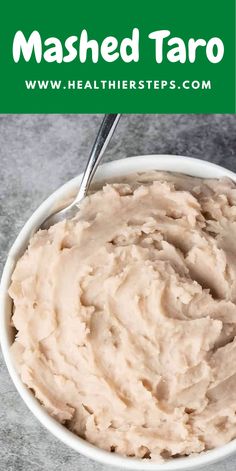 a white bowl filled with mashed potatoes on top of a table