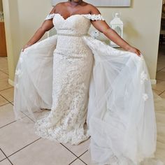 a woman in a wedding dress posing for the camera