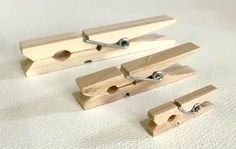 four pieces of wood with metal clips attached to them