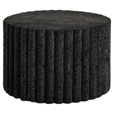 an image of a black round table with ridges on the top and bottom, made out of