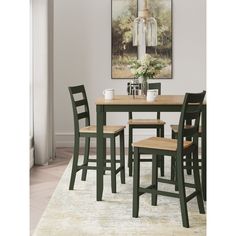 a dining room table with four chairs and a painting hanging on the wall behind it