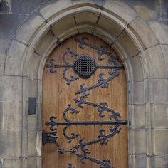 an ornate wooden door with iron work on it